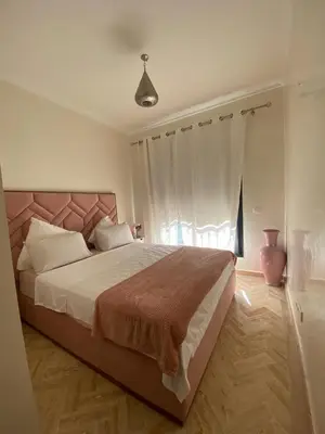 a bedroom with a large bed and a window at Chez balqis atlas golf in Marrakech