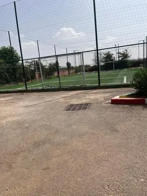 a chain link fence in front of a soccer field at Chez balqis atlas golf in Marrakech