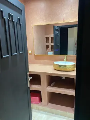 a bathroom with a sink and a mirror at Chez balqis atlas golf in Marrakech