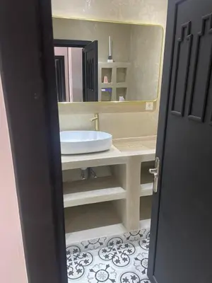 a bathroom with a sink and a large mirror at Chez balqis atlas golf in Marrakech