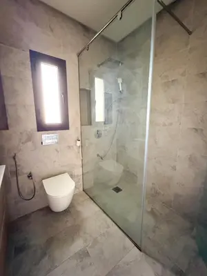 a bathroom with a glass shower with a toilet at Villa piscine privée, Détente familiale Marrakech in Marrakech