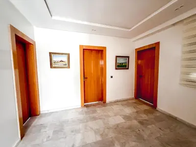 an empty hallway with two doors and tile floors at Villa piscine privée, Détente familiale Marrakech in Marrakech