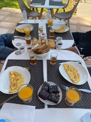 a table with plates of breakfast foods and glasses of orange juice at The BIRD in Marrakech
