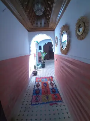 a hallway with a rug on the floor and two mirrors at Riad 9 Derb El Bousnne in Marrakech