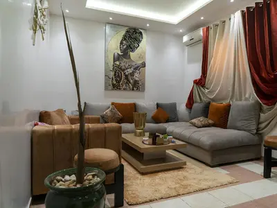 a living room with a couch and a table at RIAD DOUIRTNA in Marrakech