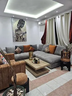a living room with a couch and a table at RIAD DOUIRTNA in Marrakech