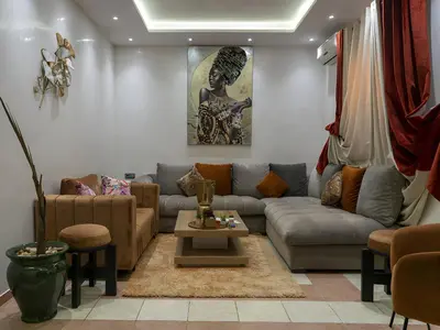 a living room with a couch and a table at RIAD DOUIRTNA in Marrakech
