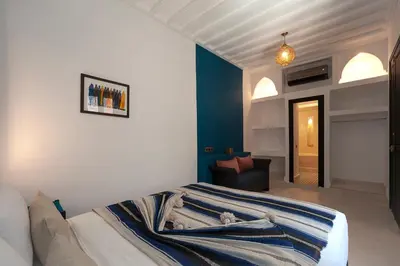 a bedroom with a bed and a couch in it at Riad Mylaya in Marrakech