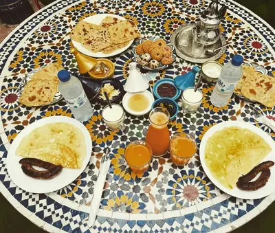 a table with plates of food and drinks on it at Archduke private rooms in Marrakech