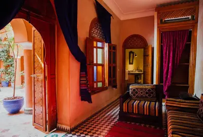 a living room with a couch and a window at Riad Bensaid in Marrakech