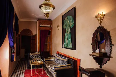a living room with a couch and a chair at Riad Bensaid in Marrakech