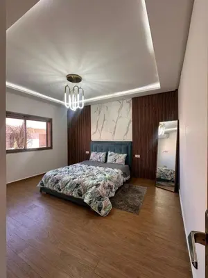 a bedroom with a bed and a chandelier at villa with private pool only family in Marrakech