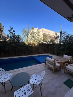 a patio with a table and chairs next to a pool at villa with private pool only family in Marrakech