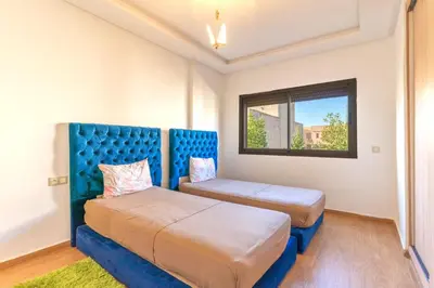 a bedroom with two beds and a window at villa with private pool only family in Marrakech