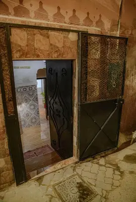 an open door in a room with a tile wall at Riad Paradise privatisé au cœur des souks in Marrakech
