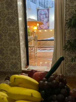a pile of bananas and other fruits on a table at Riad Paradise privatisé au cœur des souks in Marrakech