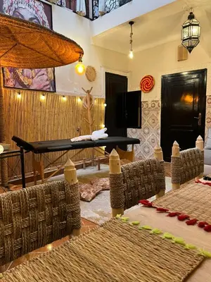 a living room with a table and chairs at Riad Paradise privatisé au cœur des souks in Marrakech