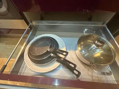 a glass case with a hat and a whisk and plates at Appartement Marrakech avec piscine in Marrakech