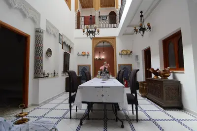 a dining room with a table and chairs at RYAD RDATE LWALIDINE in Marrakech