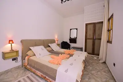 a bedroom with two beds in a room at RYAD RDATE LWALIDINE in Marrakech