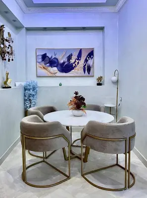 a dining room with a table and two chairs at Palmeraie 5 Vue Piscine et Jardin in Marrakech