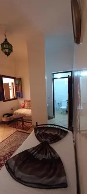 a room with a bed and a living room at Riad chaoui house in Marrakech