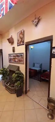a living room with an open door to a room with plants at Riad chaoui house in Marrakech