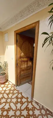 an open wooden door in a room with a floor at Riad chaoui house in Marrakech
