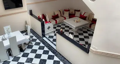 a living room with a couch and a table at Riad Lyna in Marrakech