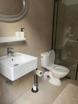 a bathroom with a sink and a toilet and a shower at Riad Lyna in Marrakech