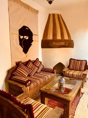 a living room with two couches and a table at Riad Laksiba in Marrakech