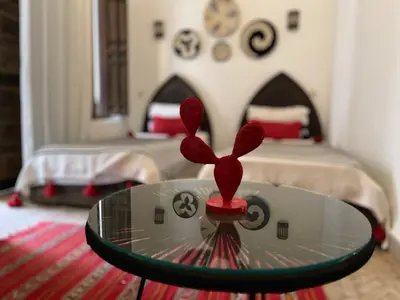 a room with a glass table in front of a bedroom at Riad Laksiba in Marrakech