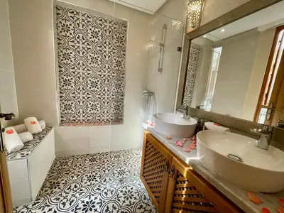 a bathroom with a sink and a mirror at Riad Al Hamama in Marrakech