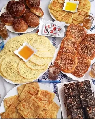 a table full of different types of pastries and desserts at Riad Al Hamama in Marrakech