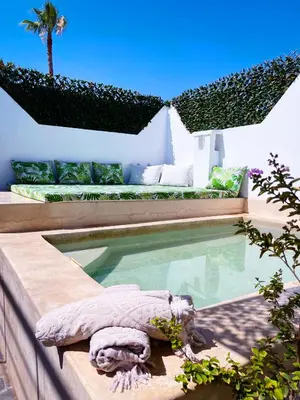 a swimming pool in the backyard of a house at Riad Al Hamama in Marrakech