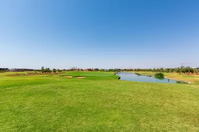 a view of the green at the golf course at Villa Nounja Golf Amelkis Marrakech in Marrakech