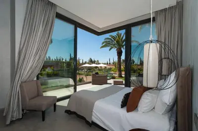 a bedroom with a bed and a large window at Villa Dar Balou - FAMILY ONLY in Marrakech