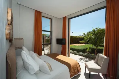 a bedroom with a bed and a large window at Villa Dar Balou - FAMILY ONLY in Marrakech