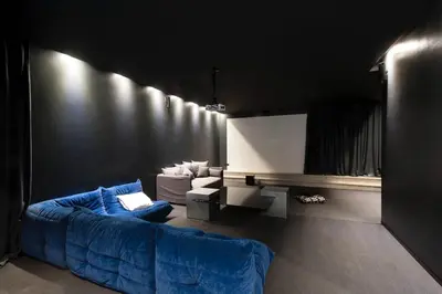 a living room with a blue couch and a tv at Villa Dar Balou - FAMILY ONLY in Marrakech