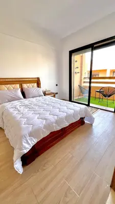a bedroom with a large bed and a large window at Luxury Apartment in the center of Gueliz Marrakech in Marrakech