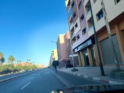 a person walking down a street next to a building at Luxury Apartment in the center of Gueliz Marrakech in Marrakech