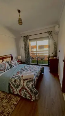 a bedroom with a bed and a large window at Luxury Apartment in the center of Gueliz Marrakech in Marrakech