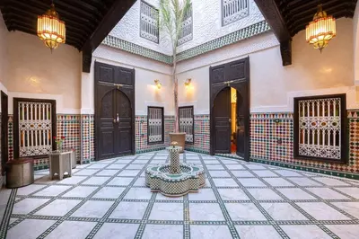a courtyard with a fountain in the middle of a building at Riad Mazaj in Marrakech
