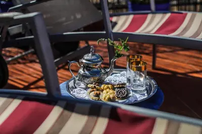 a table with a tray of food and a tea kettle at Riad For S in Marrakech