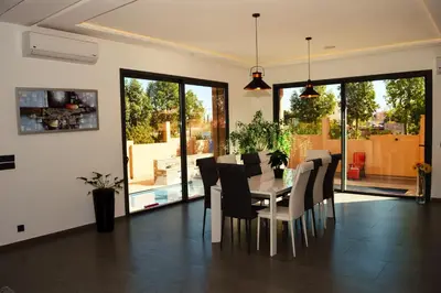 a dining room with a table and chairs at Villa Arabic House Pool & SPA, Marrakech in Marrakech