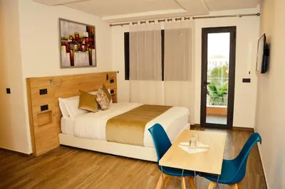 a bedroom with a bed and a table and chairs at Villa Arabic House Pool & SPA, Marrakech in Marrakech