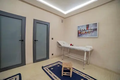 a room with a table and a chair in it at Villa Arabic House Pool & SPA, Marrakech in Marrakech