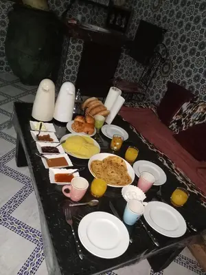 a tray of food on a table with plates of food at Riad taddert in Marrakech