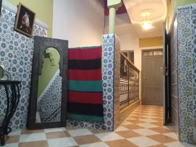 a room with a hallway with a door with a mirror at Riad taddert in Marrakech