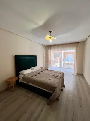 a bedroom with a large bed and a window at Appartement chambre salon centre de Gueliz 22 in Marrakech